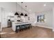 Bright open kitchen with modern white cabinets, stainless steel appliances, and large island at 345 W Wilshire Dr, Phoenix, AZ 85003