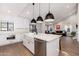 Bright, open kitchen with white cabinets, farmhouse sink, and modern stainless steel appliances at 345 W Wilshire Dr, Phoenix, AZ 85003