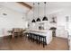 Bright open kitchen featuring a vaulted ceiling, modern white cabinets, and a large island with bar stools at 345 W Wilshire Dr, Phoenix, AZ 85003