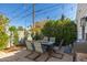 Outdoor living space features a grill and an elegant patio set beneath ambient string lights at 345 W Wilshire Dr, Phoenix, AZ 85003