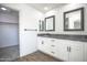 Modern bathroom featuring dual sinks, gray countertops, and wood-look flooring at 35771 W Costa Blanca Dr, Maricopa, AZ 85138