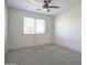 Bedroom showcasing a window, plush carpet, neutral paint, and a modern ceiling fan with light at 35771 W Costa Blanca Dr, Maricopa, AZ 85138