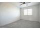 A serene bedroom featuring neutral colors, plush carpet, a window, and fresh paint at 35771 W Costa Blanca Dr, Maricopa, AZ 85138