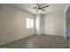 Bright bedroom with wood-look floors, neutral walls, and a window for natural light at 35771 W Costa Blanca Dr, Maricopa, AZ 85138