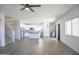 Open living area with kitchen, wood floors, natural light, and a staircase at 35771 W Costa Blanca Dr, Maricopa, AZ 85138