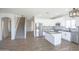 Open living area with kitchen, wood floors, natural light, and a staircase at 35771 W Costa Blanca Dr, Maricopa, AZ 85138