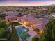 Aerial view of a house with an expansive pool, several lounge chairs and mature trees at 3937 E Norcroft Cir, Mesa, AZ 85215