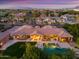 Expansive aerial view of the home showcasing the pool, outdoor living, and lush landscaping against the community backdrop at 3937 E Norcroft Cir, Mesa, AZ 85215