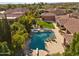 An aerial view of the home showcasing the pool, spa, fire pit, and manicured backyard at 3937 E Norcroft Cir, Mesa, AZ 85215