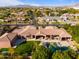 An aerial view of the estate, showcasing the expansive yard, pool, and stunning desert landscape at 3937 E Norcroft Cir, Mesa, AZ 85215