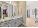 Bathroom featuring a marble counter and view to a walk-in closet at 3937 E Norcroft Cir, Mesa, AZ 85215