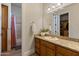 Traditional bathroom featuring wood cabinetry, granite countertop, and shower/tub combo at 3937 E Norcroft Cir, Mesa, AZ 85215