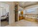 Luxurious bathroom featuring tile flooring, tub, shower, and and vanities with a view to the main bedroom at 3937 E Norcroft Cir, Mesa, AZ 85215