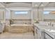 Bright bathroom featuring a soaking tub, double sink vanity, and makeup table at 3937 E Norcroft Cir, Mesa, AZ 85215