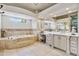 Bright bathroom featuring a soaking tub, double sink vanity, and makeup table at 3937 E Norcroft Cir, Mesa, AZ 85215