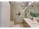 Modern bathroom with a glass shower enclosure, double sink vanity, and stylish accents at 3937 E Norcroft Cir, Mesa, AZ 85215