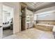 Luxurious bathroom boasts dual vanities, a soaking tub, and separate shower, creating a spa-like retreat at 3937 E Norcroft Cir, Mesa, AZ 85215