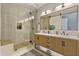 Modern bathroom featuring a glass-enclosed shower, double vanity, and sleek fixtures at 3937 E Norcroft Cir, Mesa, AZ 85215