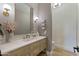 Elegant powder room with a modern sink, brass fixtures, and wall accents at 3937 E Norcroft Cir, Mesa, AZ 85215