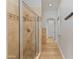 Elegant bathroom featuring a glass-enclosed shower and modern fixtures with tile accent and hardwood floors at 3937 E Norcroft Cir, Mesa, AZ 85215