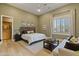 Cozy bedroom featuring neutral colors, hardwood floors, and a comfortable sitting area at 3937 E Norcroft Cir, Mesa, AZ 85215