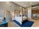 Bright bedroom showcasing a canopy bed, blue accents, and natural light at 3937 E Norcroft Cir, Mesa, AZ 85215