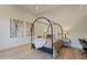 Stylish bedroom featuring a four-poster bed, artwork, and modern decor at 3937 E Norcroft Cir, Mesa, AZ 85215