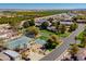 Aerial view of a well-maintained community featuring tennis and basketball courts, with lush landscaping and nearby homes at 3937 E Norcroft Cir, Mesa, AZ 85215