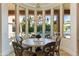 Dining room boasts a chandelier and views of the pool and waterfall feature, creating a serene atmosphere at 3937 E Norcroft Cir, Mesa, AZ 85215