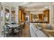 Elegant dining area with chandelier, table seating six, and seamless transition to the living room and kitchen at 3937 E Norcroft Cir, Mesa, AZ 85215