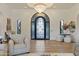 Elegant entryway featuring a decorative door, hardwood floors, and stylish accents at 3937 E Norcroft Cir, Mesa, AZ 85215