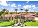 Stunning single-Gathering home featuring lush landscaping, mature palm trees, and charming water fountain at 3937 E Norcroft Cir, Mesa, AZ 85215
