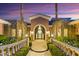 Elegant front entrance with manicured landscaping, stone accents, and a welcoming arched entryway at 3937 E Norcroft Cir, Mesa, AZ 85215