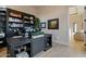 Comfortable home office features black desk, bookshelves, and modern decor at 3937 E Norcroft Cir, Mesa, AZ 85215