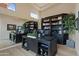 Sophisticated home office with custom bookshelves, a large desk, and bright natural light at 3937 E Norcroft Cir, Mesa, AZ 85215