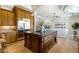 Kitchen island with stainless steel refrigerator that opens to the living room at 3937 E Norcroft Cir, Mesa, AZ 85215