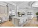 A spacious kitchen island with seating is adjacent to the living room at 3937 E Norcroft Cir, Mesa, AZ 85215