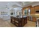 Open-concept kitchen with a large center island, custom cabinets, and seamless transition to the living space at 3937 E Norcroft Cir, Mesa, AZ 85215