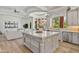 Open-concept kitchen features a large island, stainless appliances, and seamless flow into the living area at 3937 E Norcroft Cir, Mesa, AZ 85215