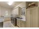 Functional laundry room with modern appliances, cabinets, sink, and ample countertop space at 3937 E Norcroft Cir, Mesa, AZ 85215