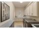 Well-equipped laundry room with modern washer/dryer, cabinets, countertop, and decor at 3937 E Norcroft Cir, Mesa, AZ 85215