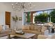 Bright living room featuring a modern chandelier and an open sliding glass door to the pool area at 3937 E Norcroft Cir, Mesa, AZ 85215