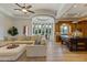 Bright living room featuring large windows, neutral tones, and an open layout to the kitchen and dining area at 3937 E Norcroft Cir, Mesa, AZ 85215