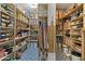 Well-organized walk-in pantry with ample shelving for storage and patterned tile flooring at 3937 E Norcroft Cir, Mesa, AZ 85215