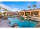 A gorgeous rock waterfall feature with an oversized pool and tanning chairs at 3937 E Norcroft Cir, Mesa, AZ 85215