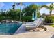 Lounge by this beautiful pool with a rock waterfall and mature landscaping, for a relaxing and private outdoor living space at 3937 E Norcroft Cir, Mesa, AZ 85215