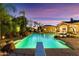 Stunning pool featuring a diving board, rock waterfall, and lush landscaping for a resort-like experience at 3937 E Norcroft Cir, Mesa, AZ 85215