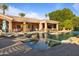 Stunning pool with rock accents, lounge chairs, and lush landscaping creates a private, resort-like backyard oasis at 3937 E Norcroft Cir, Mesa, AZ 85215