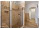 Tiled shower enclosure with a glass door and built-in bench at 3937 E Norcroft Cir, Mesa, AZ 85215