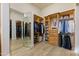 Extensive walk-in closet with wooden shelves, mirrored corner, and plenty of storage at 3937 E Norcroft Cir, Mesa, AZ 85215